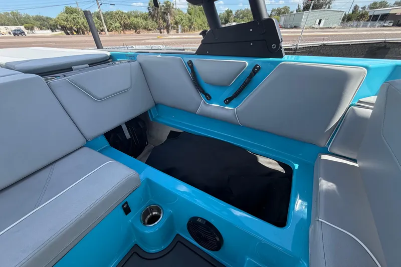 Slide: The Image of 2023 Heyday WTSurf boat interior with gray seating and blue accents. - 40