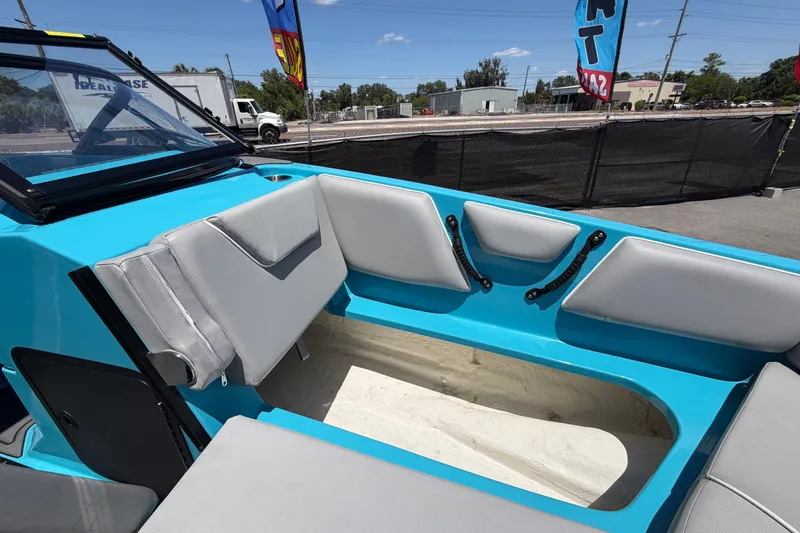 Slide: The Image of 2023 Heyday WTSurf boat interior with blue and gray seating, outdoor display. - 86