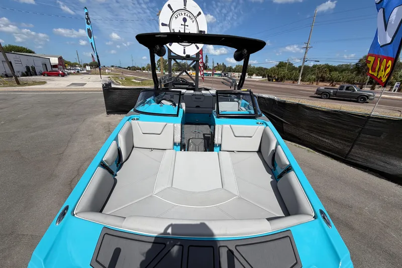 Slide: The Image of 2023 Heyday WTSurf boat with spacious seating, displayed outdoors under a clear sky. - 16