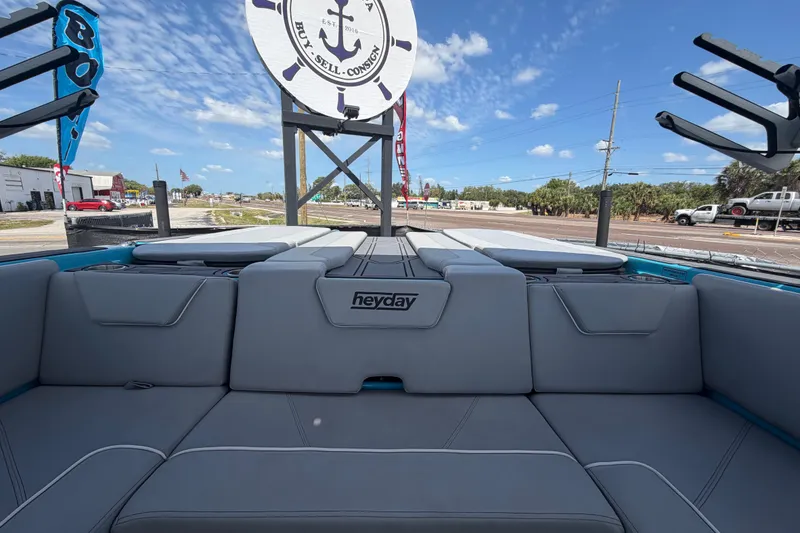 Slide: The Image of 2023 Heyday WTSurf boat interior with gray seating, outdoor setting. - 41
