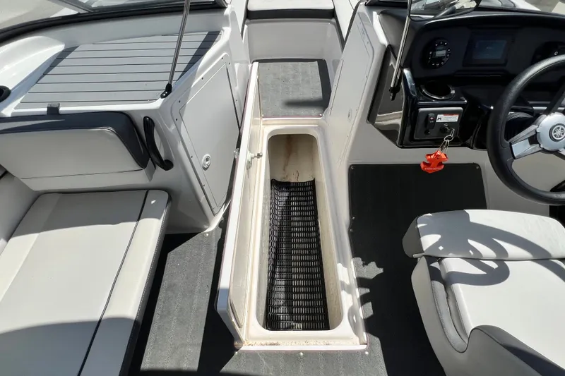 Slide: The Image of Interior view of 2022 Yamaha AR190 boat, featuring seating and storage compartment. - 31