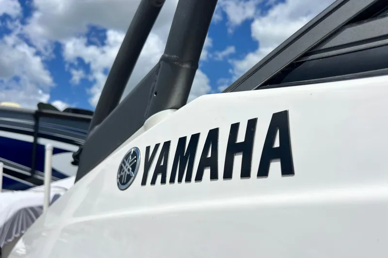 Slide: The Image of Close-up of 2022 Yamaha AR190 boat logo against a blue sky. - 13
