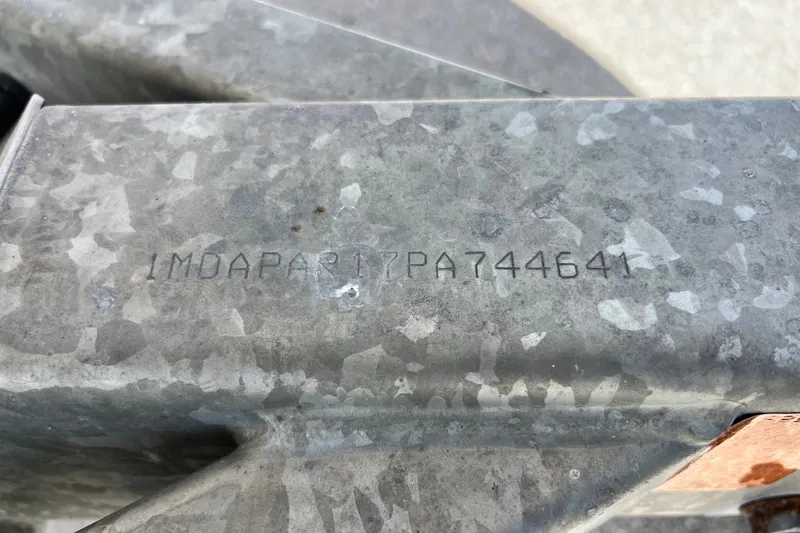 Slide: The Image of VIN number on a 2022 Yamaha Boats AR190, engraved on a metal surface. - 12