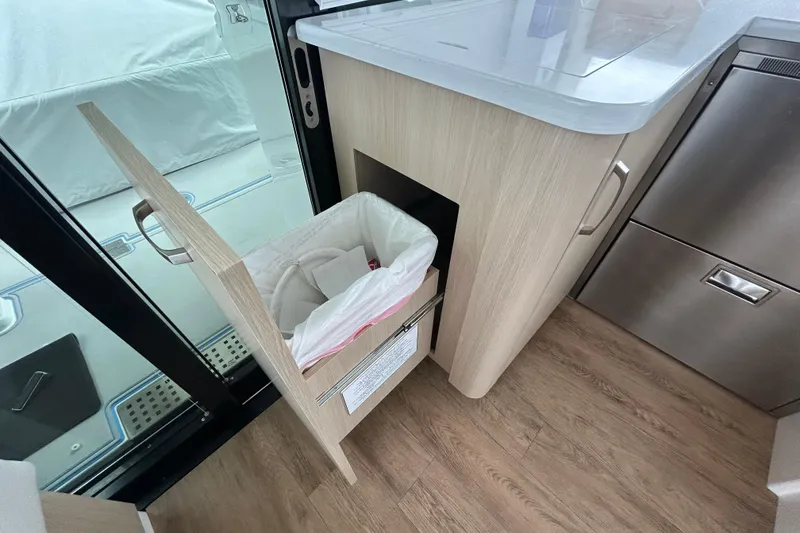 Slide: The Image of Pull-out trash bin in 2023 Regal 38 FXO yacht kitchen area. - 79