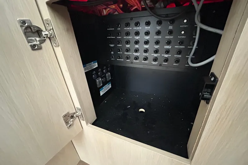 Slide: The Image of Electrical panel inside a 2023 Regal 38 FXO boat cabinet. - 72