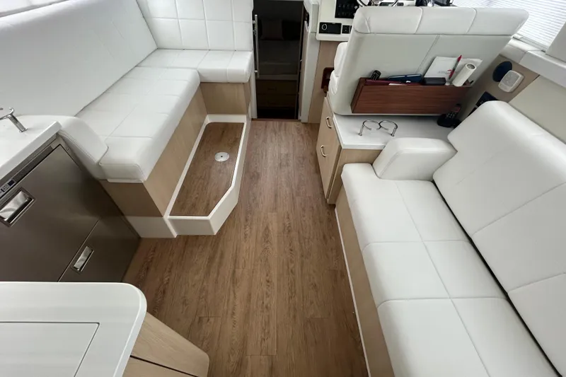 Slide: The Image of Luxurious interior of 2023 Regal 38 FXO yacht with white seating and wood flooring. - 55