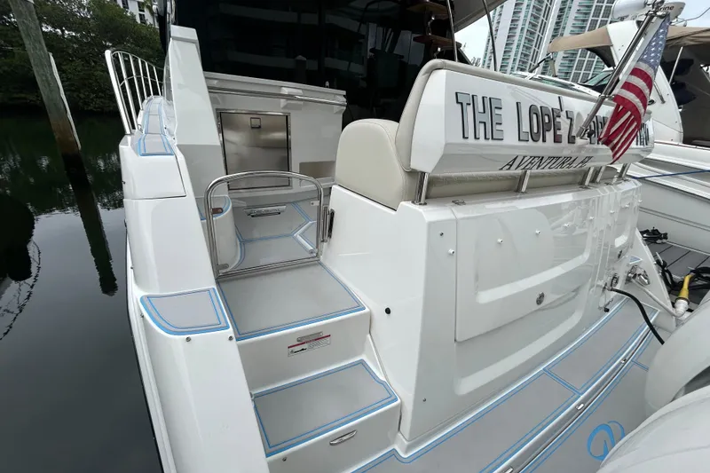 Slide: The Image of 2023 Regal 38 FXO yacht stern with American flag and custom nameplate. - 16