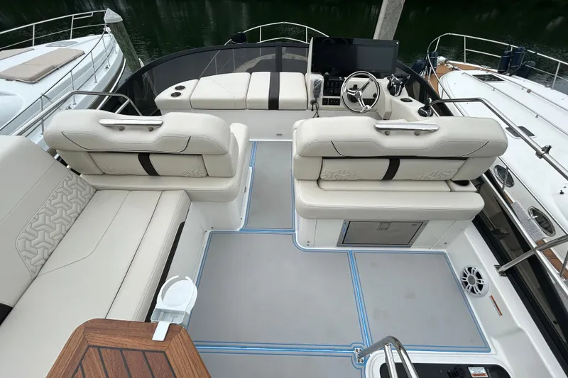 Slide: The Image of 2023 Regal 38 FXO boat interior with luxurious seating and modern helm. - 20