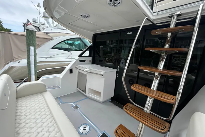 Slide: The Image of 2023 Regal 38 FXO yacht interior with sleek seating and modern staircase design. - 19