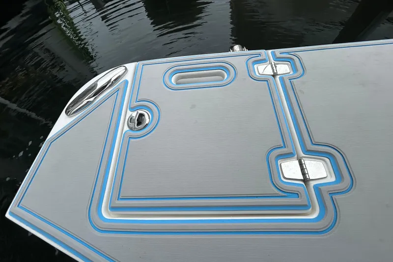 Slide: The Image of 2023 Regal 38 FXO boat deck with sleek design and blue accents. - 14