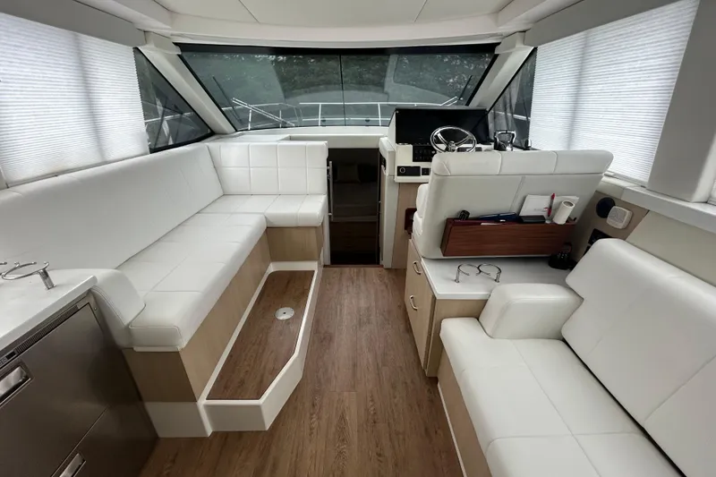 Slide: The Image of Interior of 2023 Regal 38 FXO yacht with white seating and wood flooring. - 54