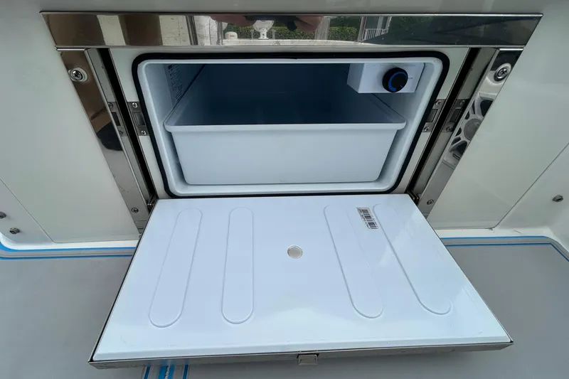 Slide: The Image of Open storage compartment on 2023 Regal 38 FXO boat, featuring sleek design and functionality. - 36