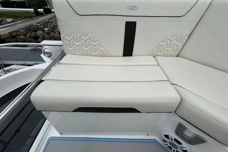 Slide: The Image of Luxurious seating on 2023 Regal 38 FXO boat with elegant white upholstery and geometric design. - 32