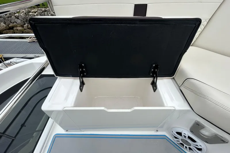 Slide: The Image of Open storage compartment on 2023 Regal 38 FXO boat, featuring cushioned seating. - 33