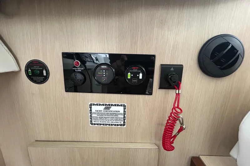 Slide: The Image of Control panel of 2023 Regal 38 FXO yacht with safety features and certification label. - 70