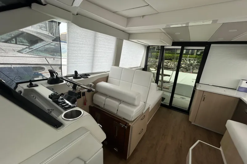 Slide: The Image of Interior of 2023 Regal 38 FXO yacht with modern seating and helm controls. - 75