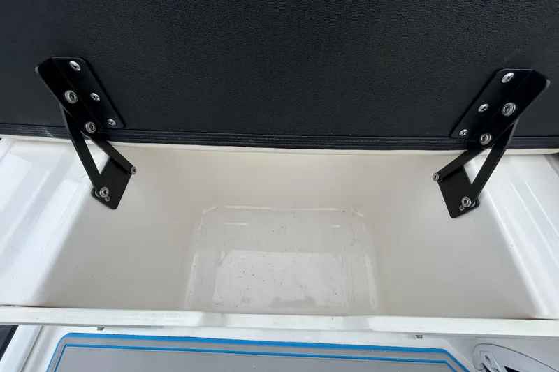 Slide: The Image of Open storage compartment on 2023 Regal 38 FXO boat, featuring sturdy hinges. - 34
