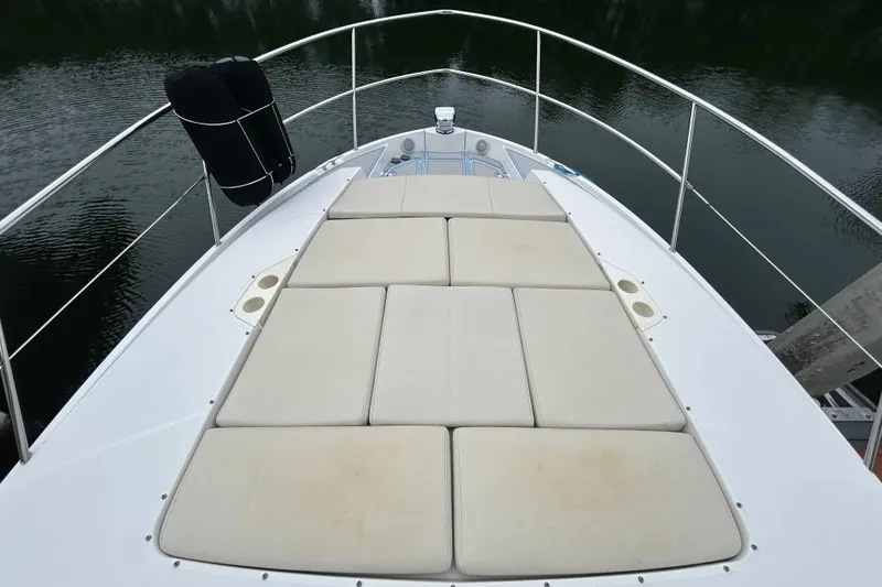 Slide: The Image of Bow view of 2023 Regal 38 FXO yacht with cushioned sunbathing area. - 40