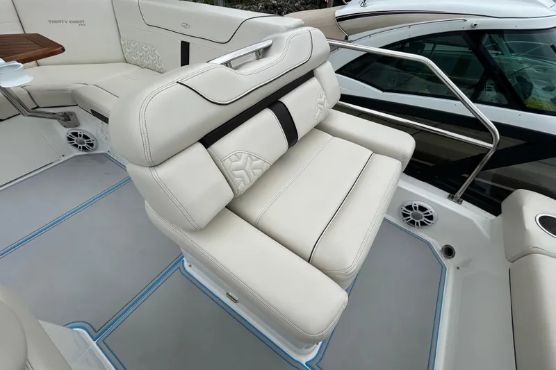 Slide: The Image of Luxurious seating on 2023 Regal 38 FXO boat, featuring elegant white upholstery and modern design. - 25