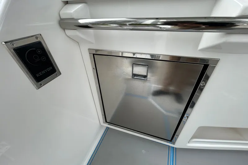 Slide: The Image of 2023 Regal 38 FXO boat interior with Kenyon control panel and stainless steel compartment. - 46