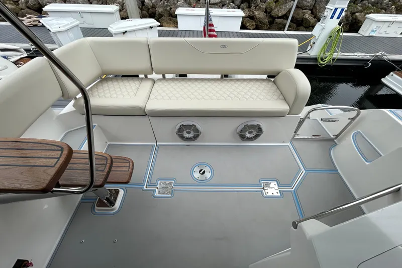 Slide: The Image of 2023 Regal 38 FXO boat interior with cushioned seating and sleek design. - 51