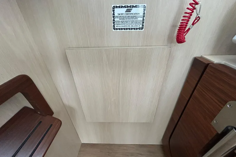 Slide: The Image of Interior of 2023 Regal 38 FXO yacht with certification plaque and safety cord. - 71