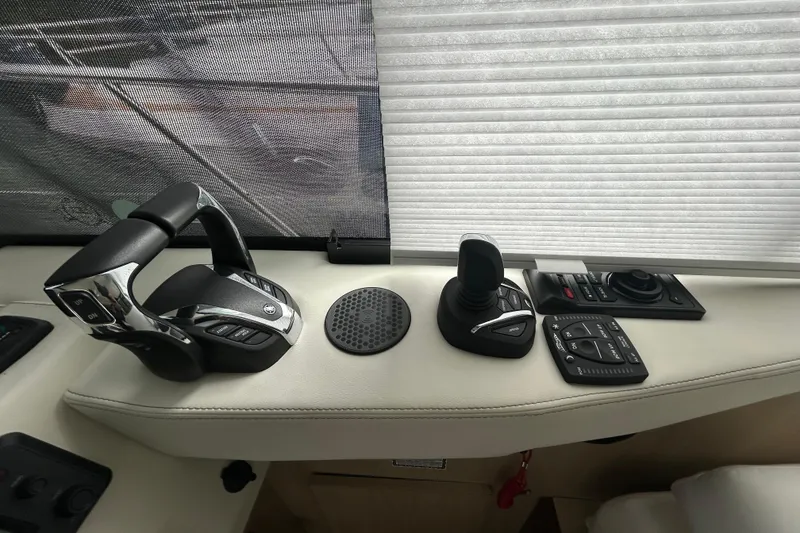 Slide: The Image of Control panel of 2023 Regal 38 FXO boat with joystick and throttle controls. - 68