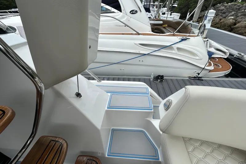 Slide: The Image of 2023 Regal 38 FXO yacht interior with elegant seating and docked boat view. - 52