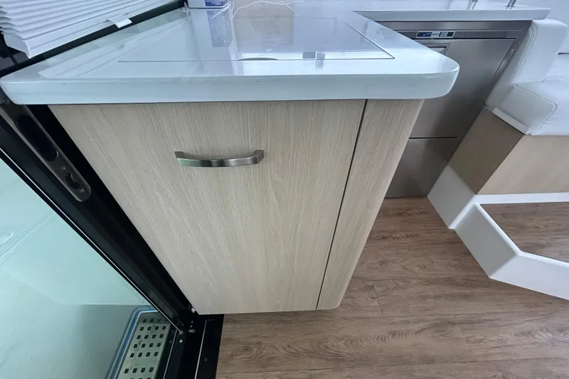 Slide: The Image of Modern interior of 2023 Regal 38 FXO yacht with sleek cabinetry and wood flooring. - 78