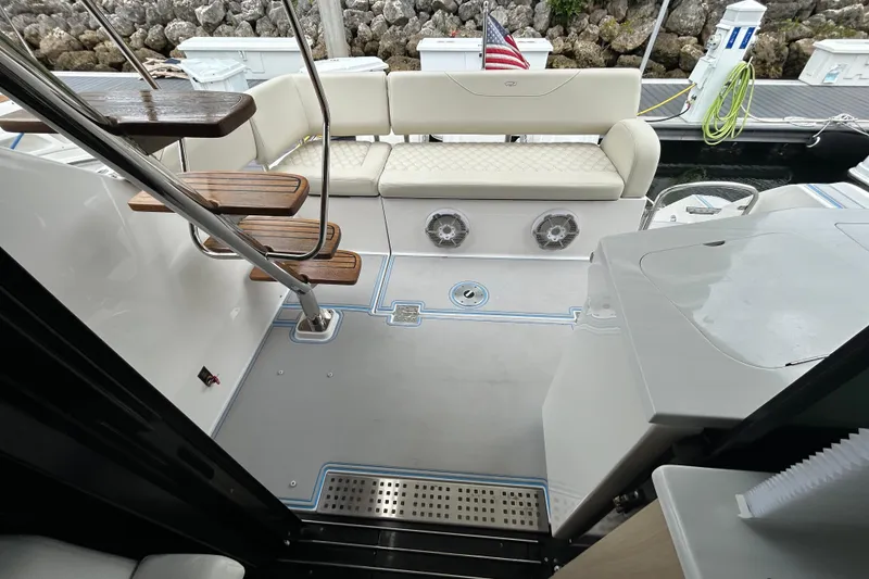 Slide: The Image of 2023 Regal 38 FXO yacht interior with elegant seating and wooden steps. - 50