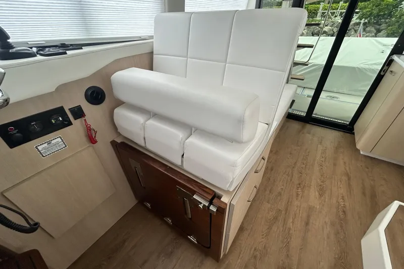 Slide: The Image of Luxurious interior seating of 2023 Regal 38 FXO yacht with white upholstery and wooden accents. - 61