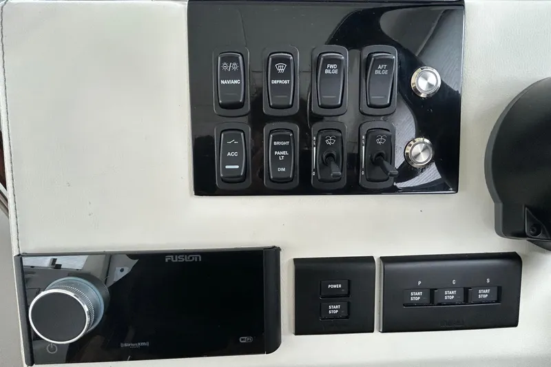Slide: The Image of Control panel of 2023 Regal 38 FXO boat with various switches and buttons. - 66