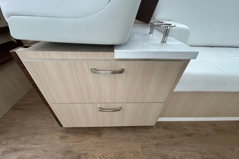 Slide: The Image of 2023 Regal 38 FXO interior with wooden drawers and white seating. - 58