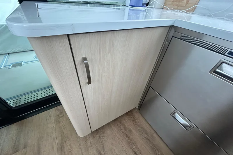 Slide: The Image of Modern kitchen area in 2023 Regal 38 FXO boat with sleek cabinetry and stainless steel appliances. - 80