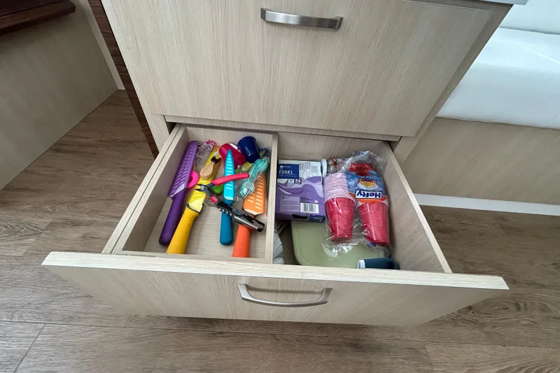 Slide: The Image of Open drawer with colorful kitchen utensils and disposable cups in a Regal 38 FXO, 2023 model. - 59