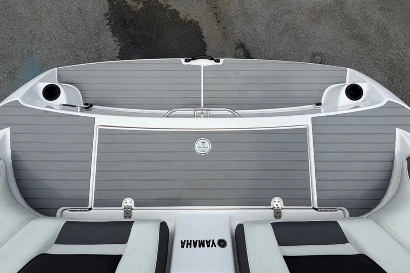 Slide: The Image of 2022 Yamaha AR210 boat swim platform with gray decking and cup holders. - 61
