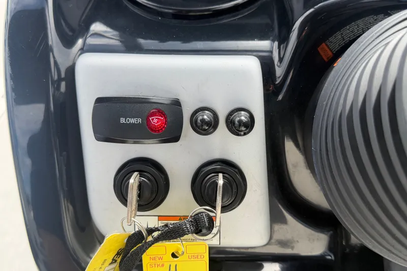 Slide: The Image of Control panel of a 2022 Yamaha Boats AR210 with blower switch and ignition keys. - 27