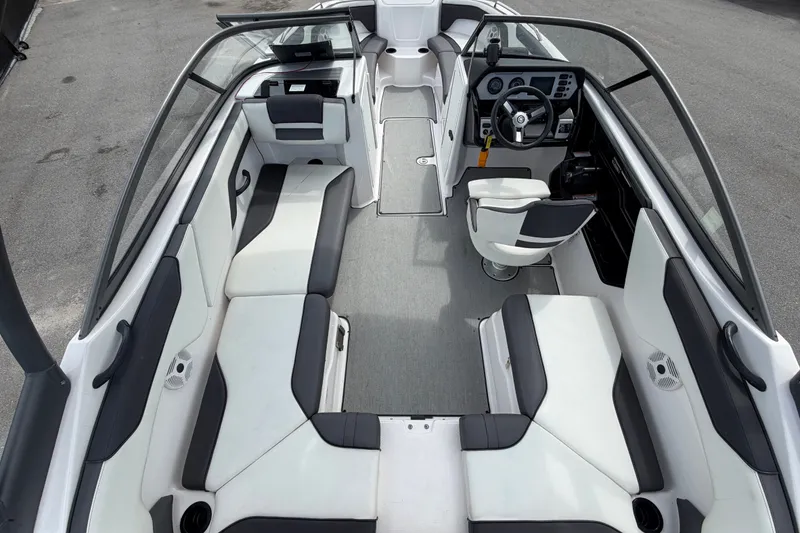 Slide: The Image of 2022 Yamaha Boats AR210 interior with sleek seating and modern dashboard design. - 15
