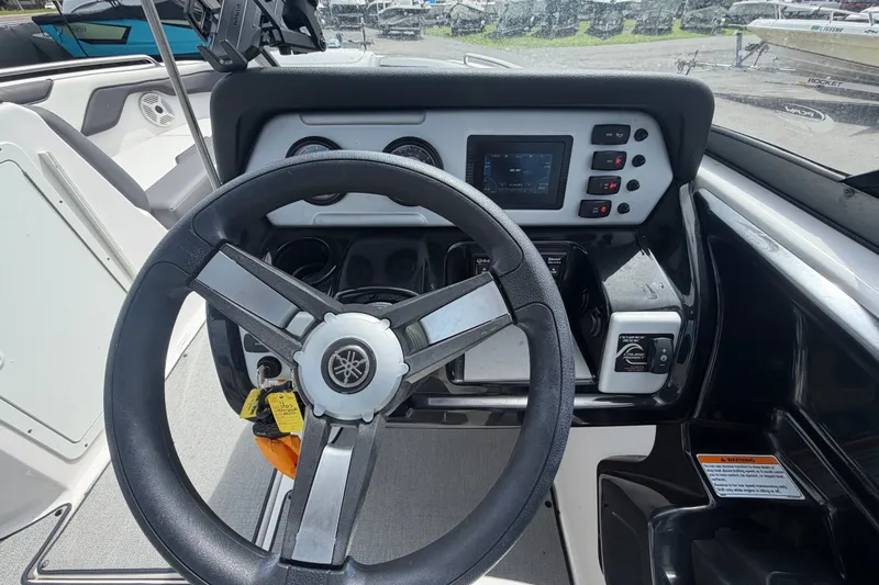 Slide: The Image of 2022 Yamaha AR210 boat dashboard with steering wheel and control panel. - 24