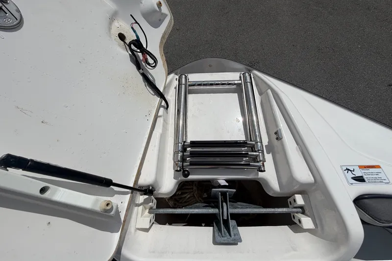 Slide: The Image of 2022 Yamaha Boats AR210 swim platform with retractable ladder and storage compartment. - 42