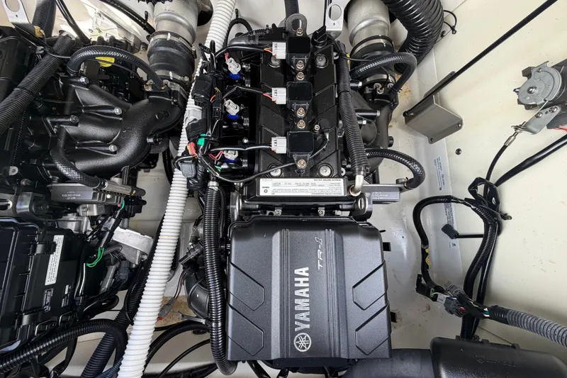 Slide: The Image of Engine compartment of a 2022 Yamaha Boats AR210, showcasing intricate wiring and components. - 57