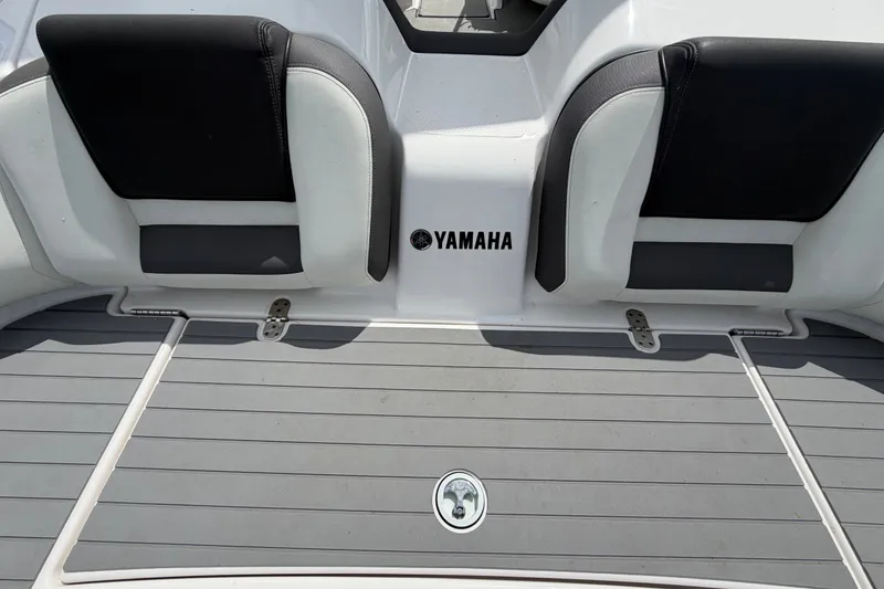 Slide: The Image of 2022 Yamaha Boats AR210 swim platform with cushioned seating and sleek design. - 12