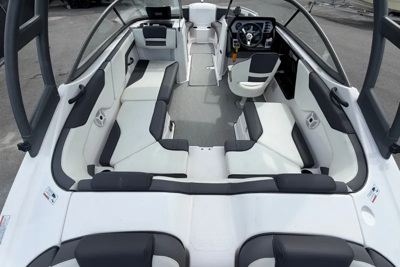 Slide: The Image of 2022 Yamaha Boats AR210 interior with sleek seating and modern dashboard design. - 14