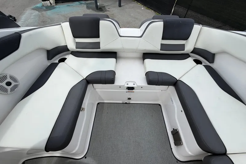 Slide: The Image of 2022 Yamaha Boats AR210 interior seating with black and white upholstery. - 52
