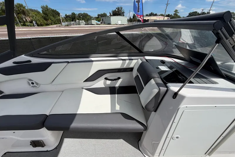 Slide: The Image of 2022 Yamaha Boats AR210 interior with sleek seating and modern dashboard design. - 18