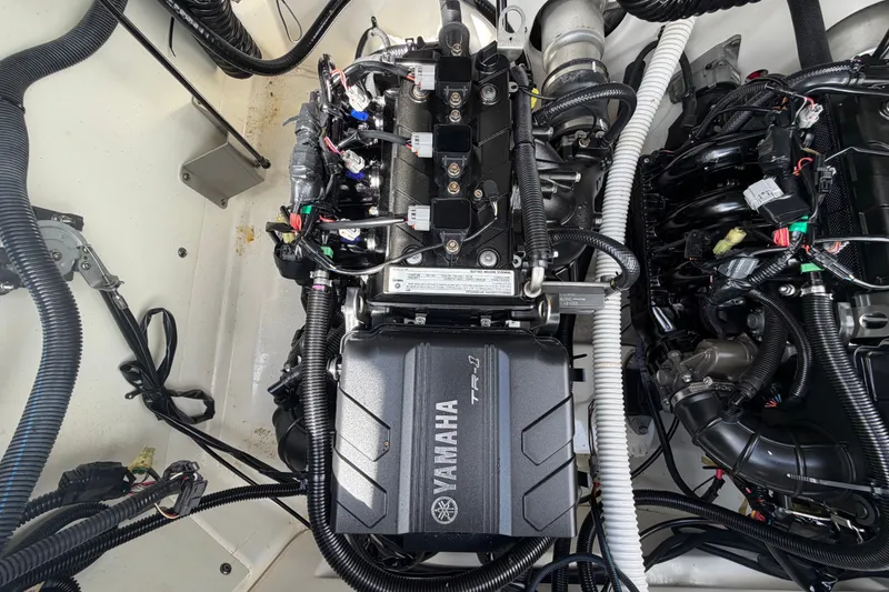 Slide: The Image of Engine compartment of a 2022 Yamaha Boats AR210, showcasing intricate wiring and components. - 56