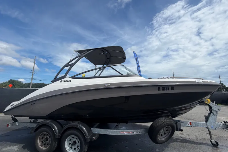 Slide: The Image of 2022 Yamaha Boats AR210 on trailer under blue sky. - 1