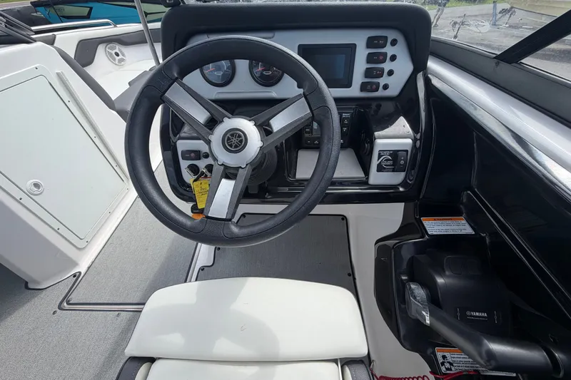 Slide: The Image of 2022 Yamaha Boats AR210 steering console with modern controls and dashboard. - 23