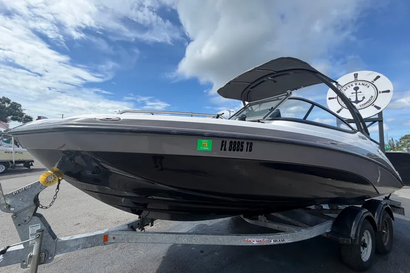Slide: The Image of 2022 Yamaha Boats AR210 on trailer under cloudy sky. - 7