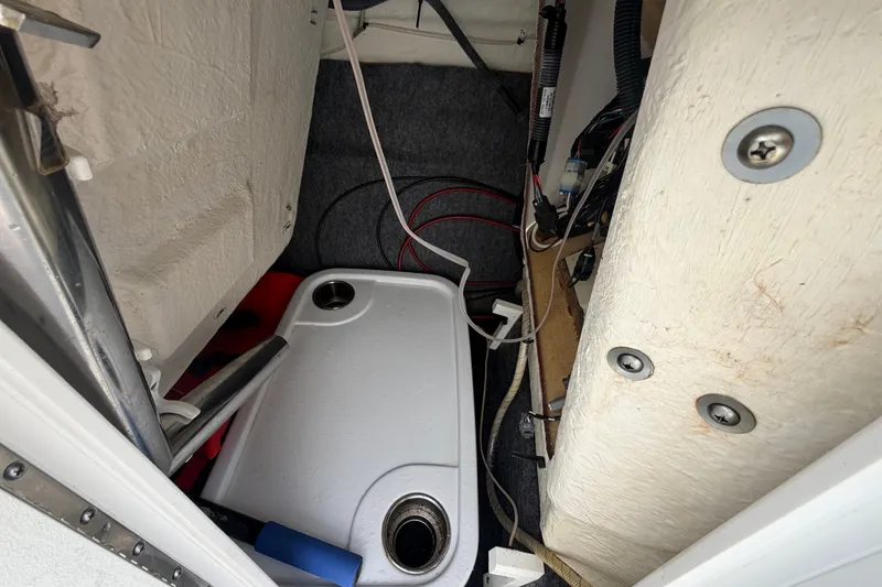 Slide: The Image of Interior view of a 2022 Yamaha AR210 boat showing wiring and storage compartment. - 38